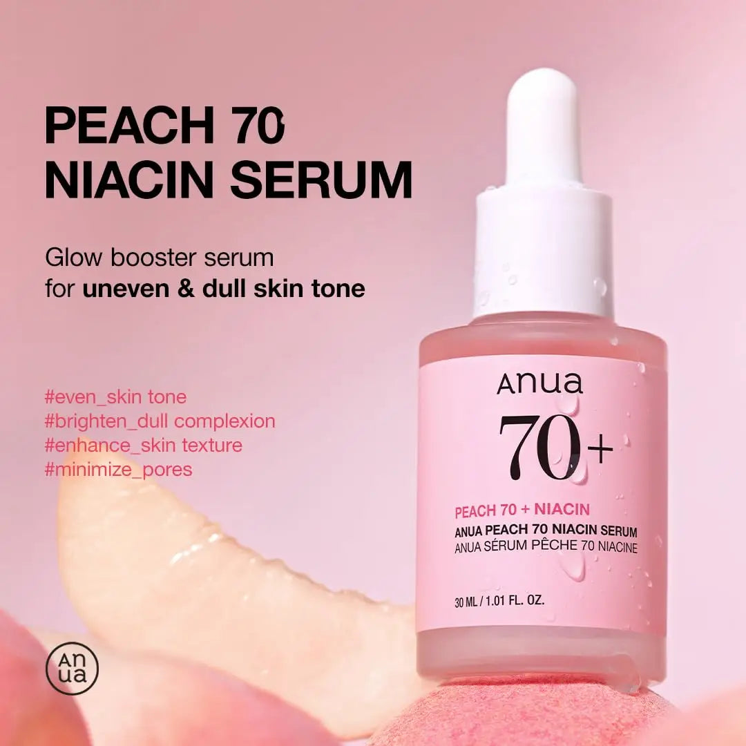 Bottle of Anua Peach 70 Niacinamide Serum 30ml with pink label and dropper on pink background, promoting glow booster for uneven and dull skin tone.