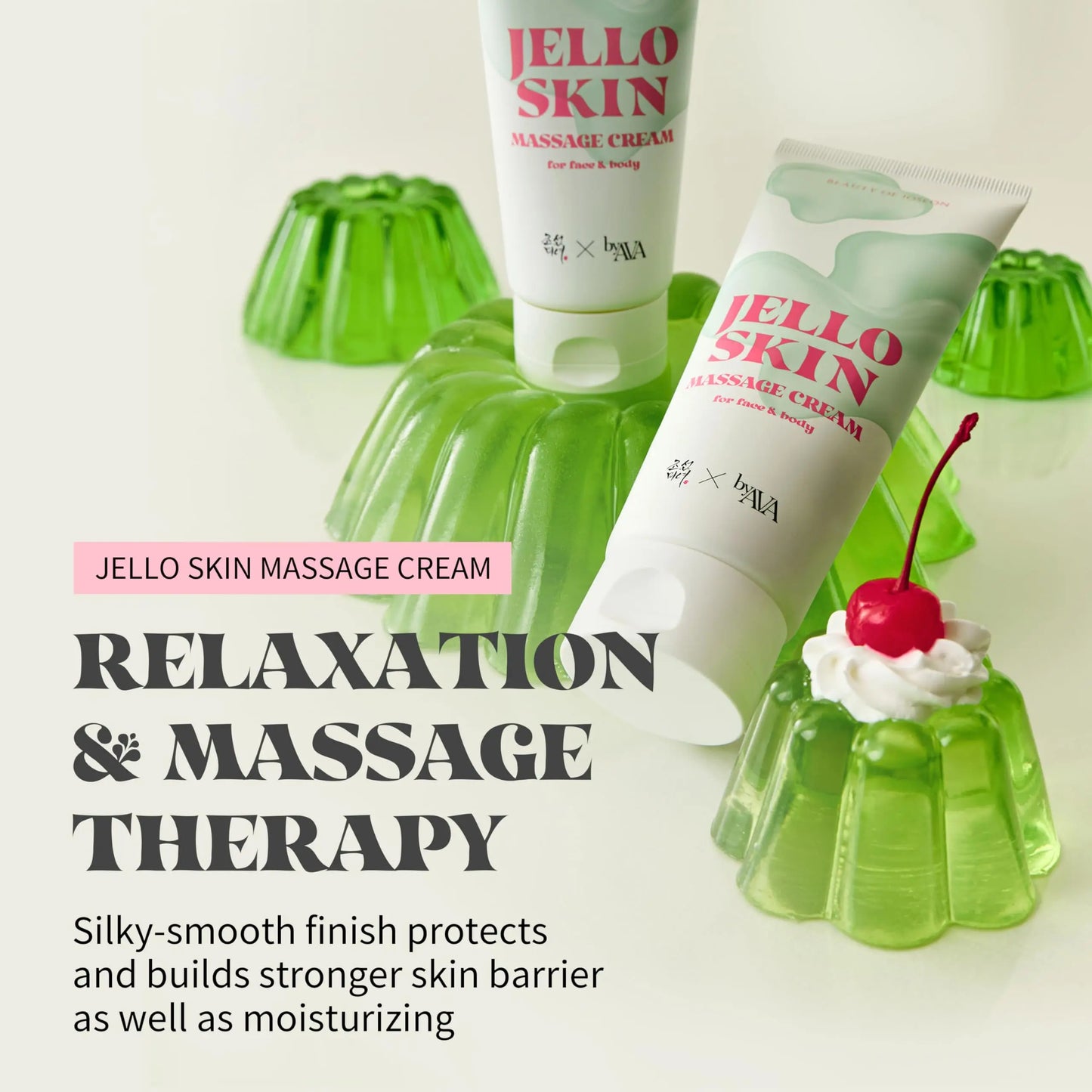 Two tubes of Beauty of Joseon Jelloskin Massage Cream for Face and Body 200ml placed on and around green jelly molds with a small dessert topped with a cherry, highlighting the product's smooth, moisturizing massage benefits.