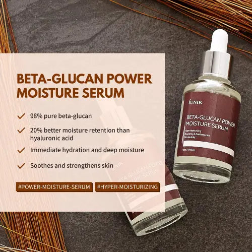 A clear glass bottle with silver dropper cap and maroon label of iunik beta glucan power deep moisture serum