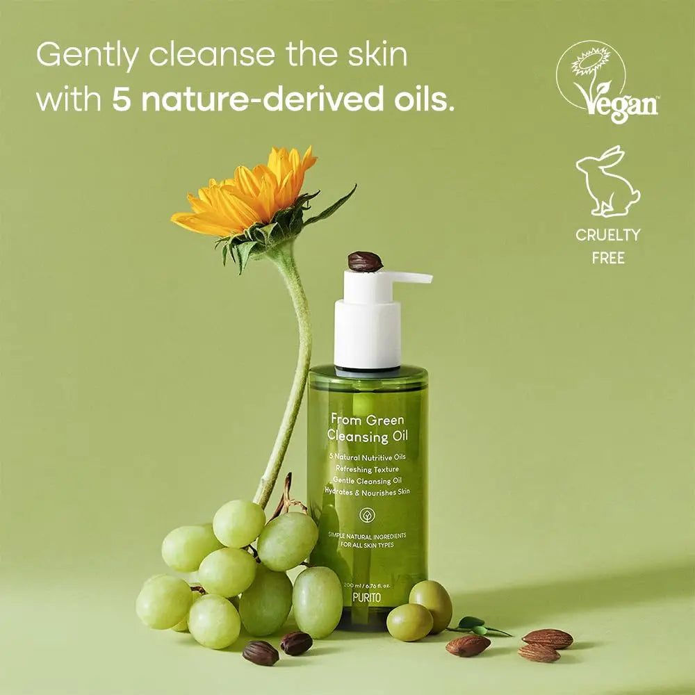PURITO From Green Cleansing Oil 200ml bottle with natural ingredients displayed alongside grapes, a sunflower, olives, and almonds, highlighting gentle cleansing with five nature-derived oils, vegan and cruelty free.