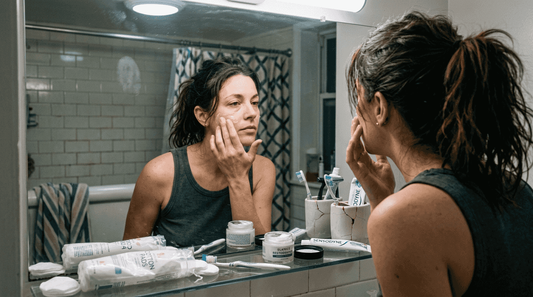 Woman applying night cream in cozy bathroom
