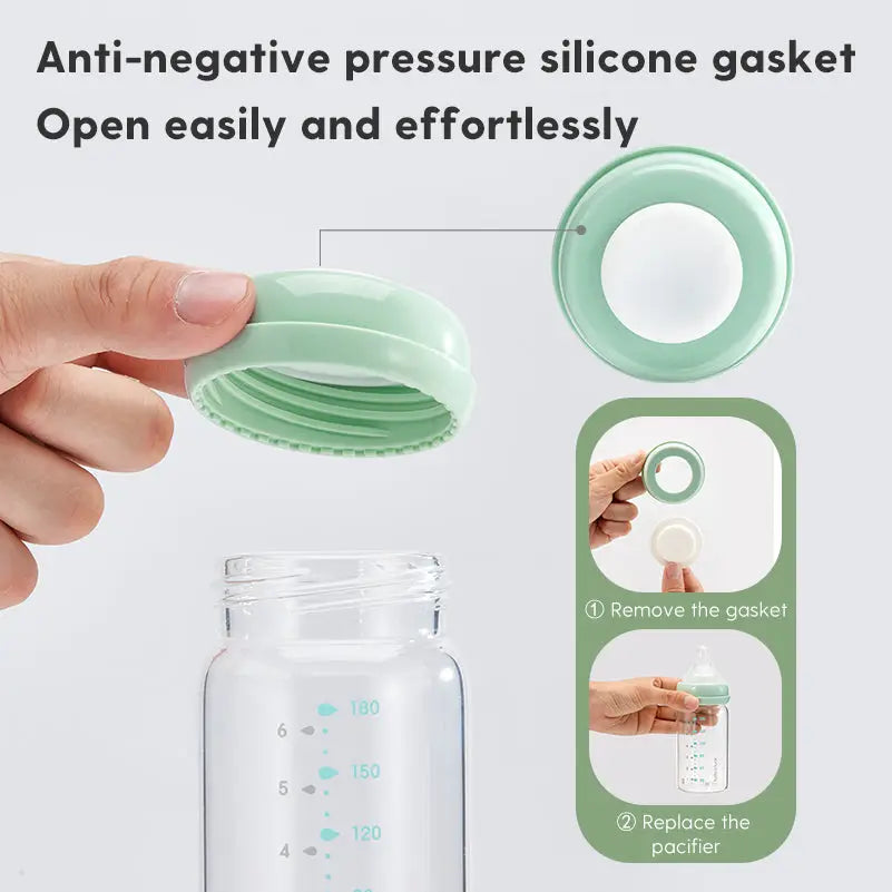 Hand holding the green anti-negative pressure silicone gasket cap being removed from a clear baby bottle with measurement markings, showing easy opening detail for All-in-One Wide-Neck Glass Baby Milk Storage Bottle | Pump Directly into Bottle Store in Refrigrator and Feed Directly from Glass Bottle| BPA-Free | Glass Breas.