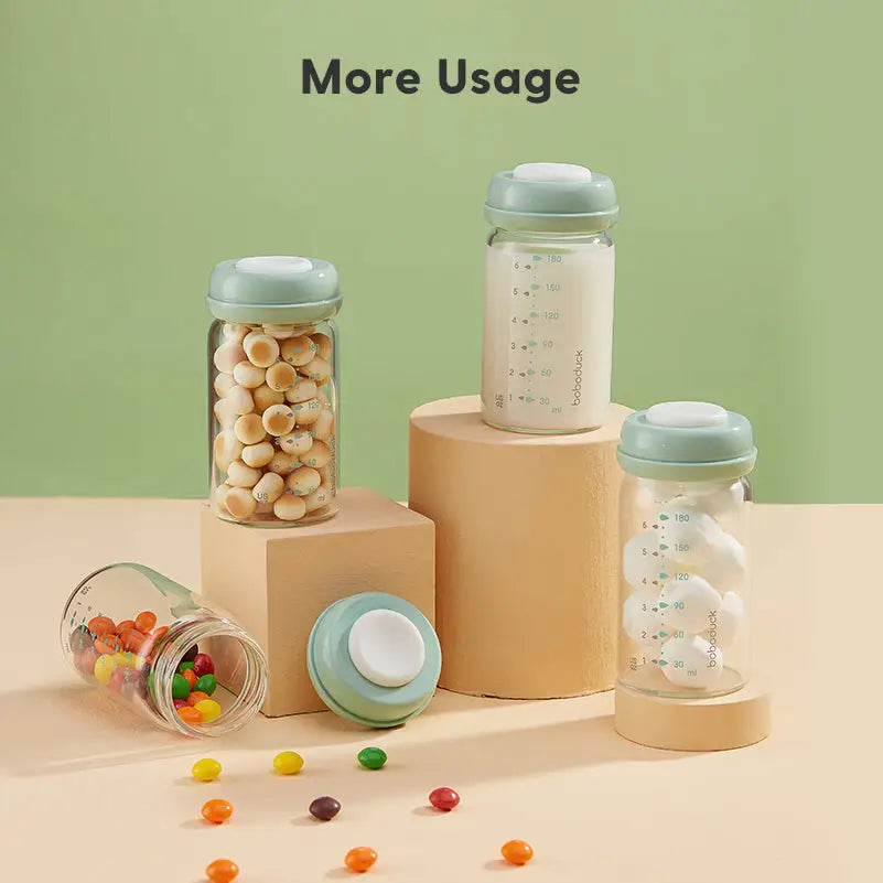 Clear glass containers with pastel green lids, filled with colorful candies, white eggs, and milk, showcasing versatile uses of the All-in-One Wide-Neck Glass Baby Milk Storage Bottle | Pump Directly into Bottle Store in Refrigrator and Feed Directly from Glass Bottle| BPA-Free | Glass Breas against a soft green background.