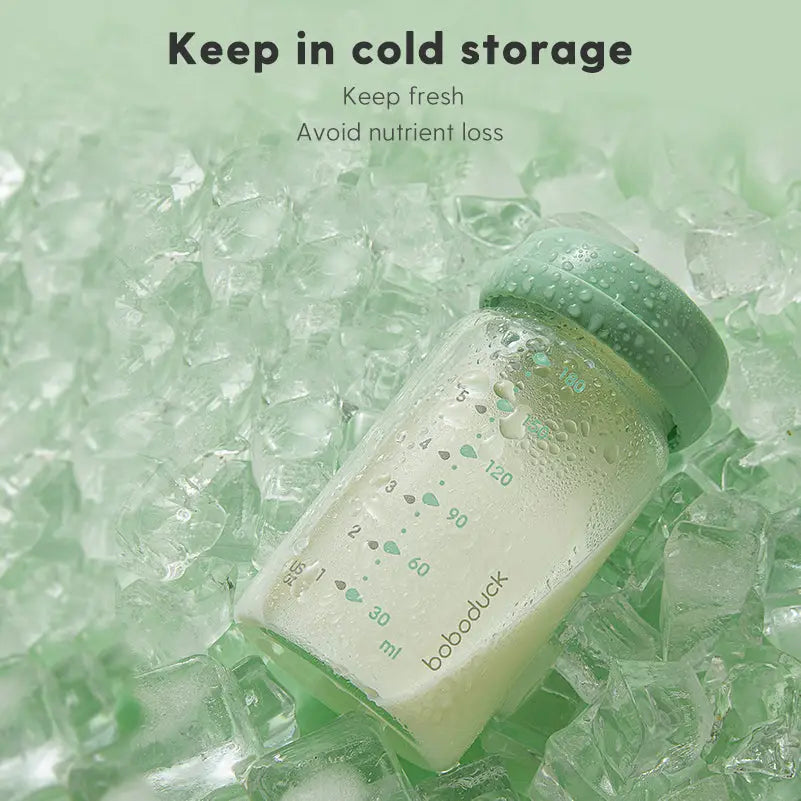 Glass baby milk storage bottle filled with milk and sealed with a green lid, placed on ice with text advising cold storage to keep fresh and avoid nutrient loss, featuring All-in-One Wide-Neck Glass Baby Milk Storage Bottle | Pump Directly into Bottle Store in Refrigrator and Feed Directly from Glass Bottle| BPA-Free | Glass Breas.