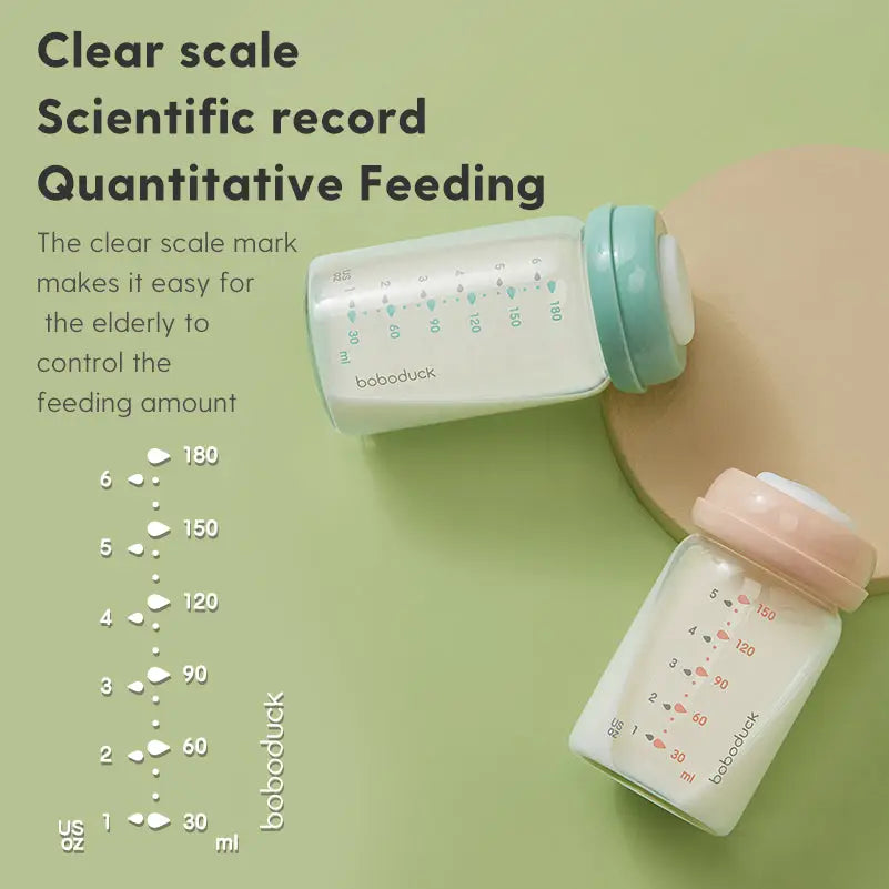 Two wide-neck glass baby milk storage bottles with clear measurement scales and pastel-colored lids on a green surface, featuring "All-in-One Wide-Neck Glass Baby Milk Storage Bottle | Pump Directly into Bottle Store in Refrigrator and Feed Directly from Glass Bottle| BPA-Free | Glass Breas" text describing easy quantitative feeding.