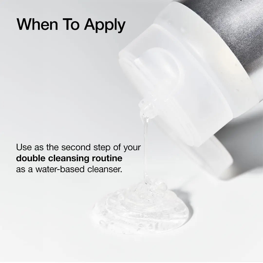 Clear gel cleanser being dispensed from a white and silver bottle onto a white surface with text explaining the product is used as the second step in a double cleansing routine as a water-based cleanser, featuring Anua 8 hyaluronic acid moisturizing gentle gel cleanser 150ml.