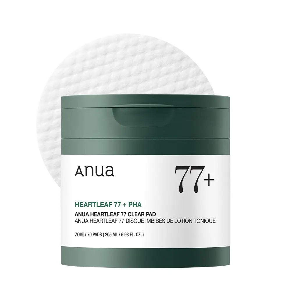 Container of ANUA Heartleaf 77 Clear Pad with dark green lid and label, accompanied by a textured round cotton pad in the background.