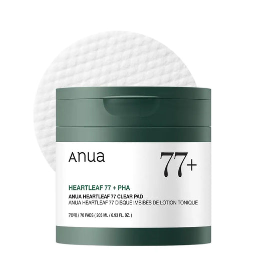 Container of ANUA Heartleaf 77 Clear Pad with dark green lid and label, accompanied by a textured round cotton pad in the background.