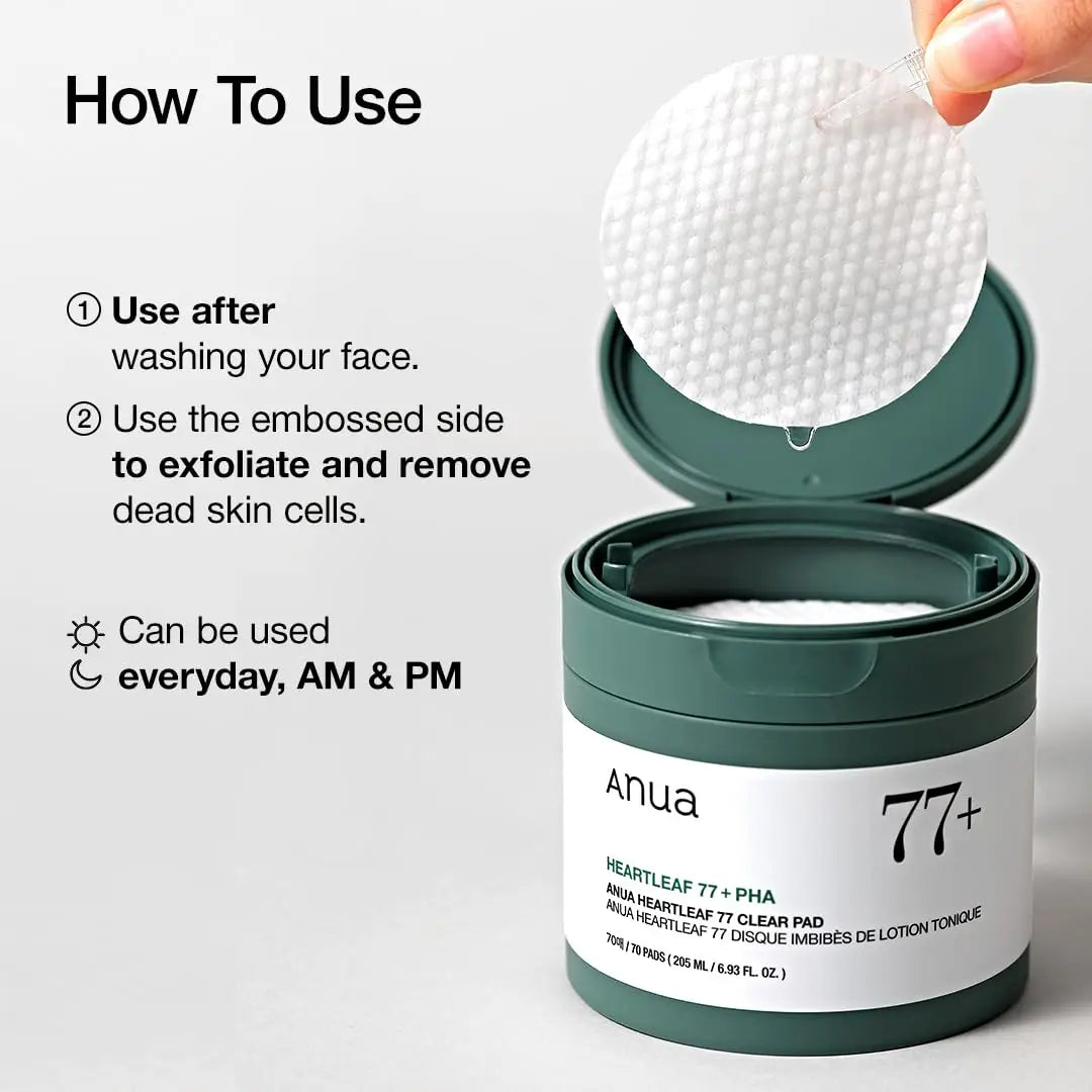Hand holding a textured white ANUA Heartleaf 77 Clear Pad above an open green and white container, demonstrating usage instructions for facial exfoliation and skin care.