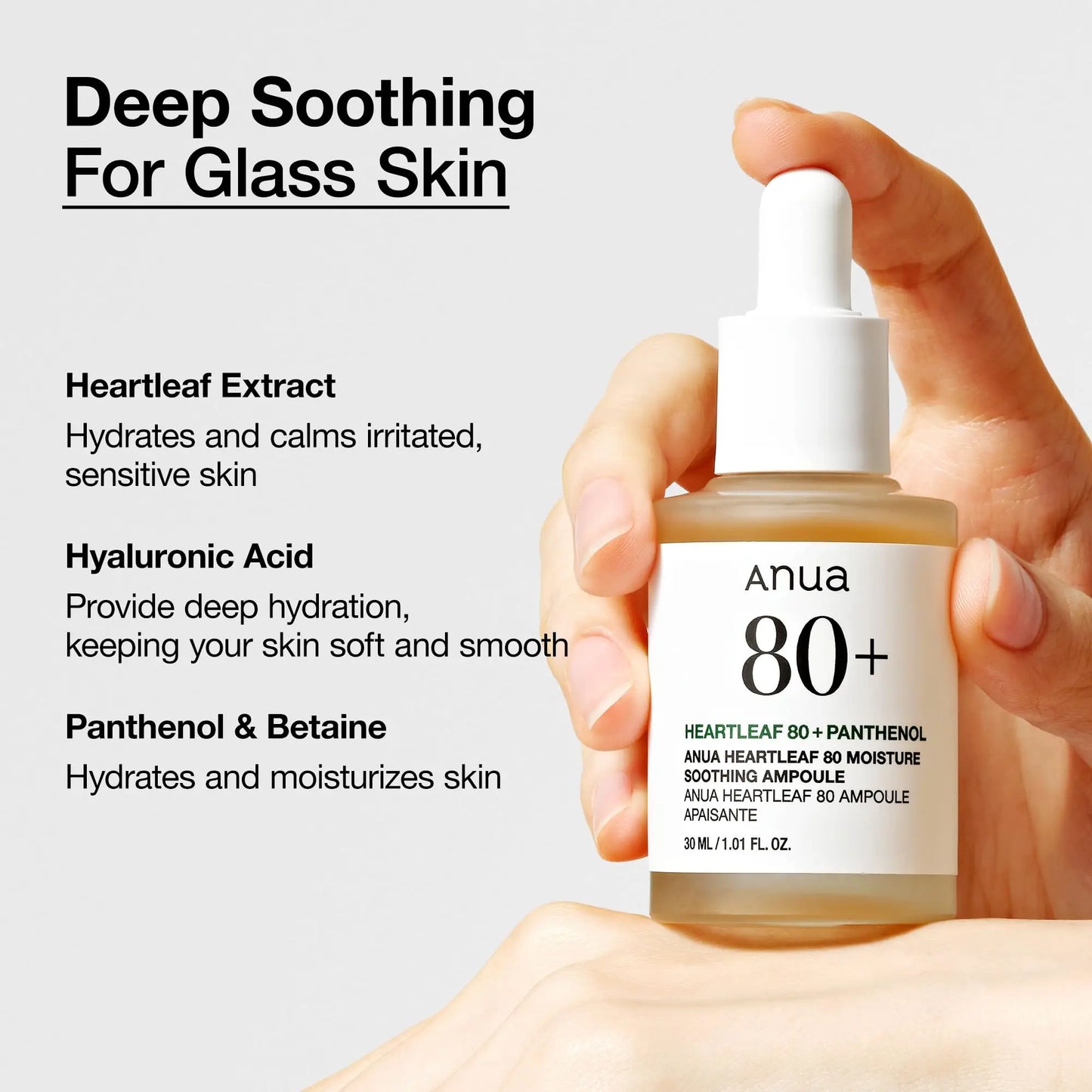 Hand holding a bottle of Anua Heartleaf 80 Soothing Ampoule 30ml with text highlighting deep soothing benefits for glass skin, including heartleaf extract, hyaluronic acid, panthenol, and betaine for hydration and calming sensitive skin.