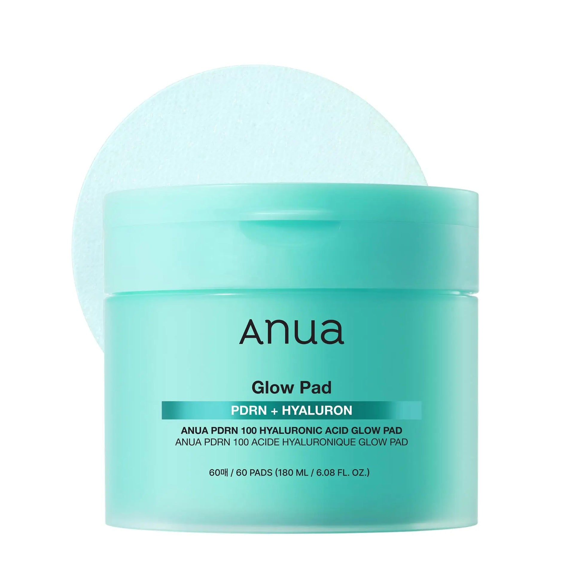 Anua PDRN Hyaluronic Glow Pad 180ml in a mint green container with a round textured pad behind it, designed for skincare hydration and glow enhancement.