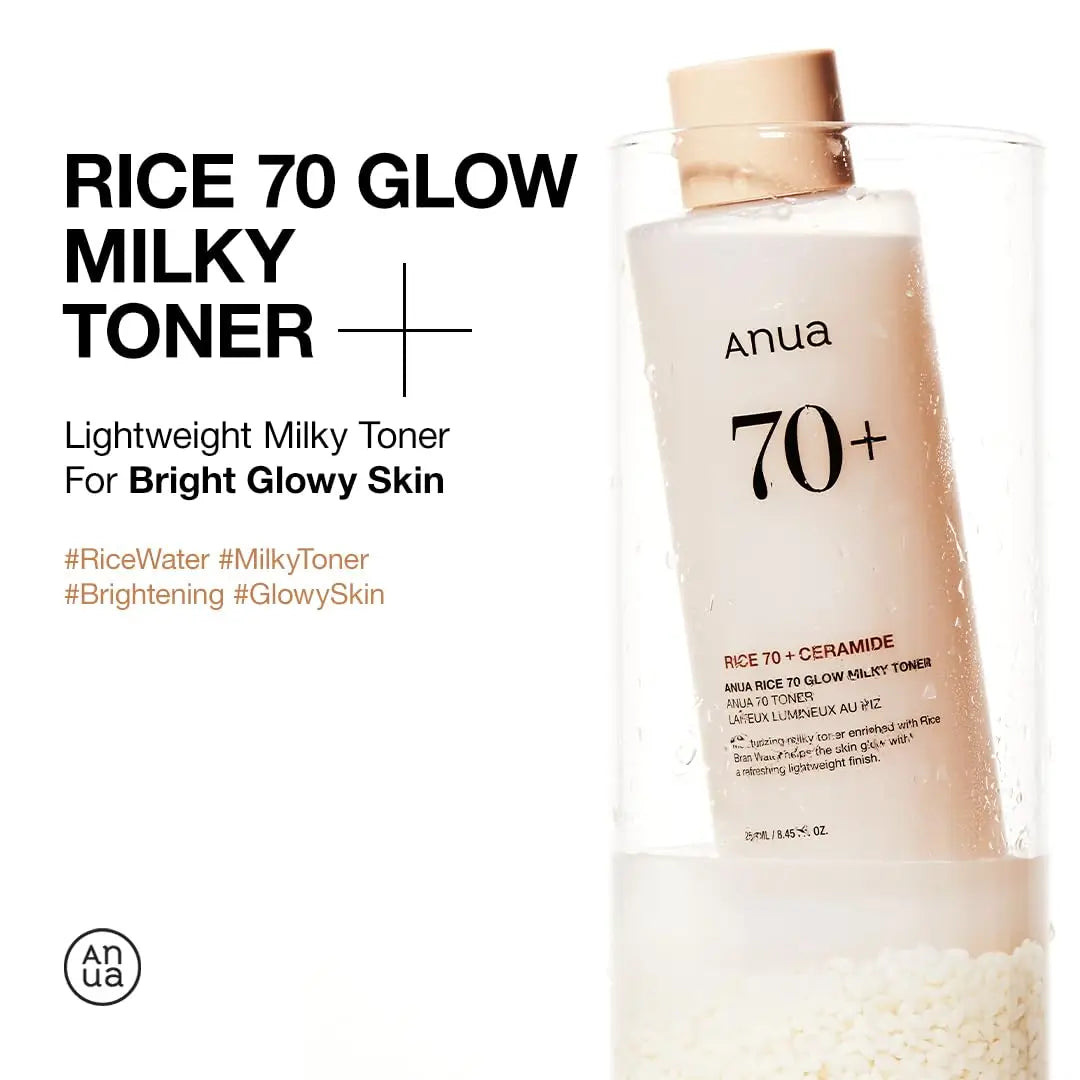 Anua rice 70 glow milky toner 250ml bottle with beige cap standing in clear container filled with rice grains, highlighting bright glowy skin benefits of lightweight milky toner.