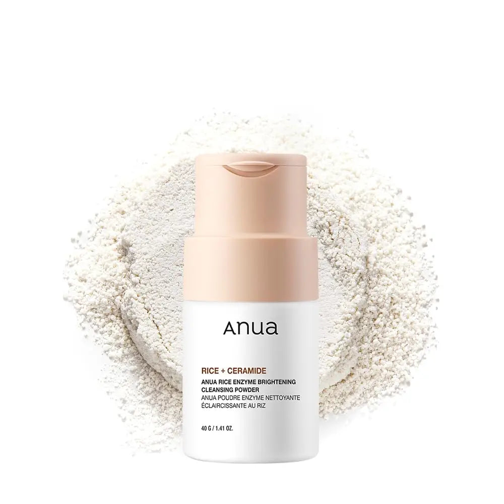 Anua Rice Enzyme Brightening Cleansing Powder 40g bottle with light beige cap surrounded by a scattered pile of fine white cleansing powder on a white background.