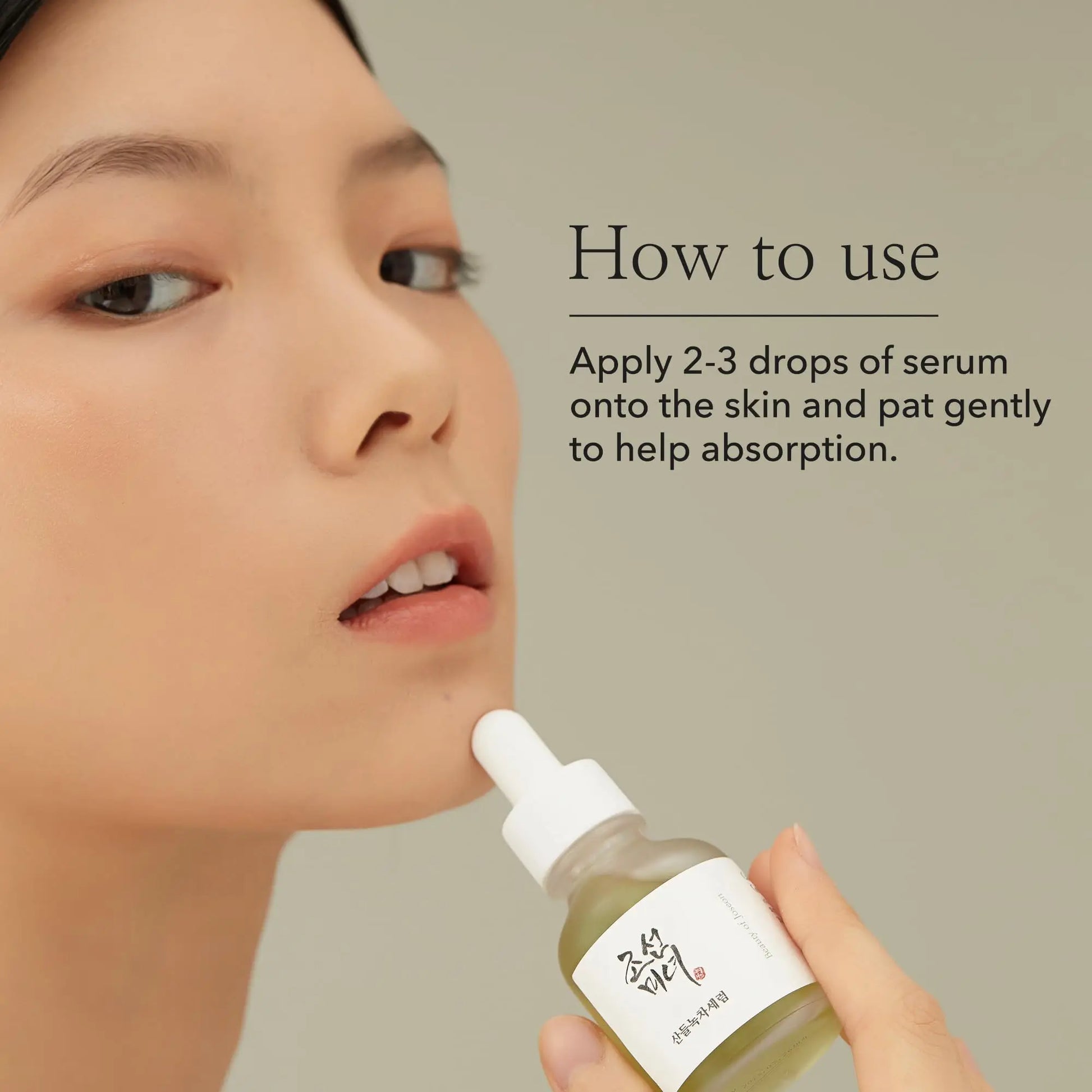 Woman gently applying Beauty of Joseon Calming Serum Green Tea Panthenol 30ml on her face with the instruction to apply 2-3 drops and pat gently for absorption.
