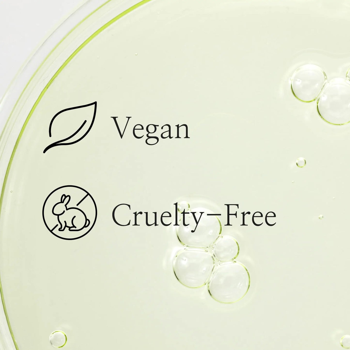 Clear liquid with bubbles in a petri dish background showing vegan and cruelty-free icons for Beauty of Joseon Calming Serum Green Tea Panthenol 30ml.