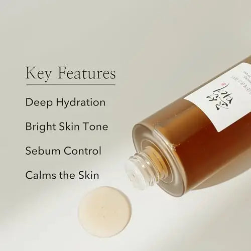 Beauty of Joseon Ginseng Essence 150ml bottle lying on its side with essence liquid drop, highlighting key features like deep hydration, bright skin tone, sebum control, and calming the skin.