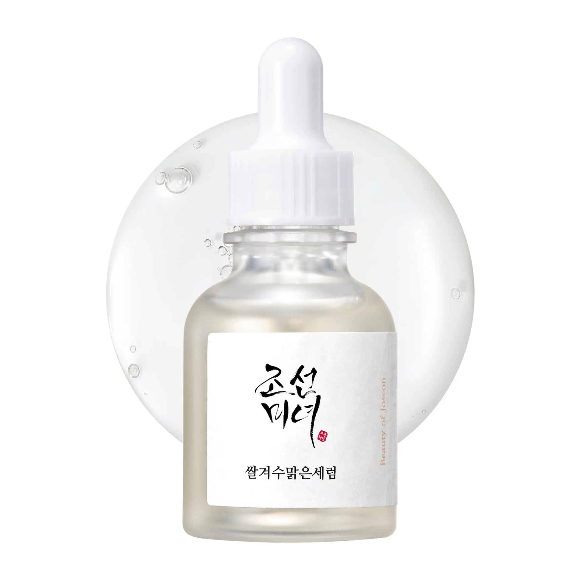 Beauty of Joseon Glow Deep Serum Rice + Alpha-Arbutin 30ml in a clear dropper bottle with a white cap placed in front of a translucent serum droplet background.