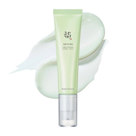 Beauty of Joseon Light On Serum Centella + Vitamin C 30ml in a soft green tube with translucent white cap, shown with creamy serum texture swatches behind it.