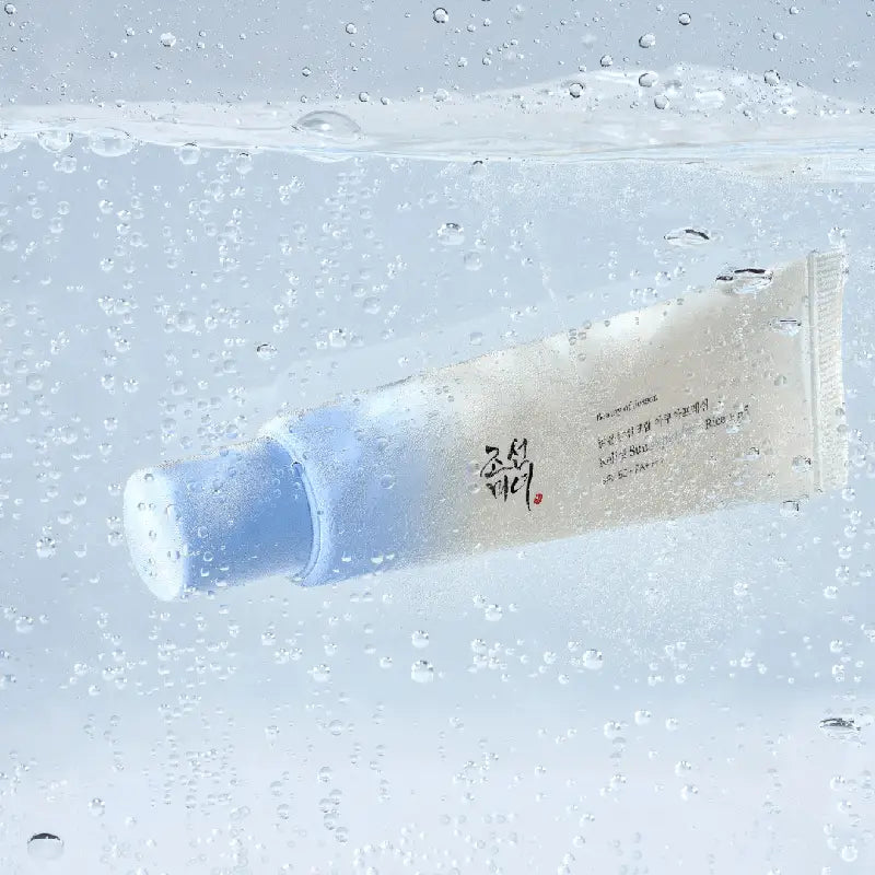Tube of Beauty of Joseon Relief Sun Aqua-Fresh : Rice + B5 sunscreen submerged in clear water with bubbles, highlighting hydration and freshness.