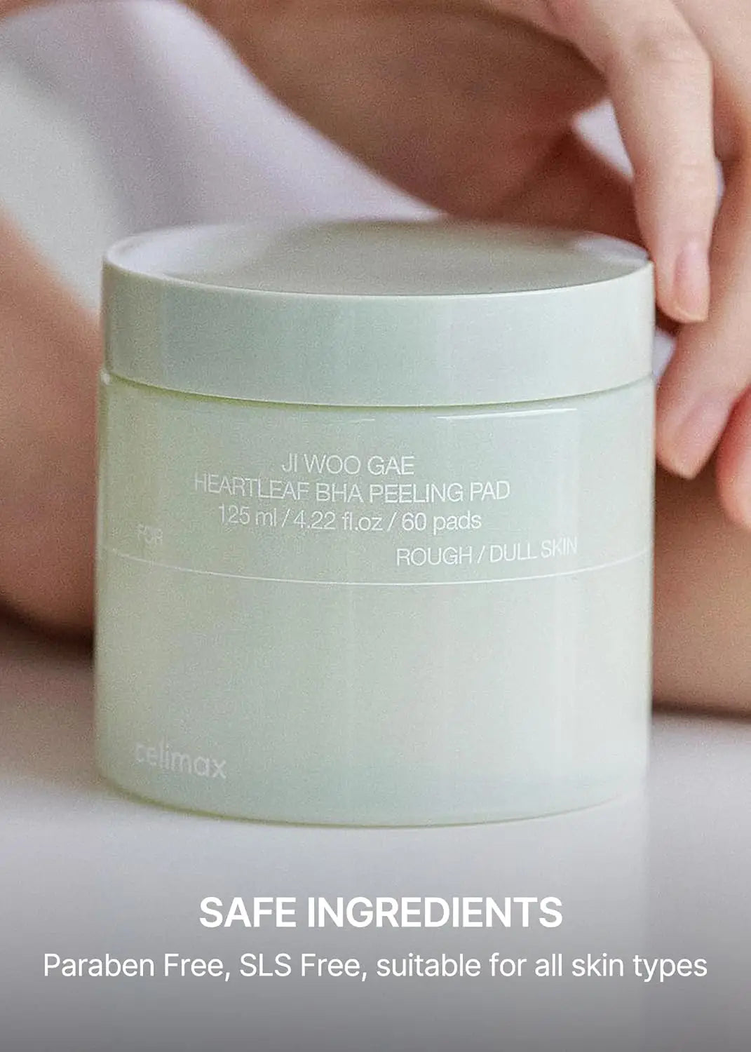celimax Ji.Woo.Gae Heartleaf BHA Peeling Pad (60 Pads) container shown with label, held by hand; emphasizes safe ingredients, paraben free and SLS free for all skin types