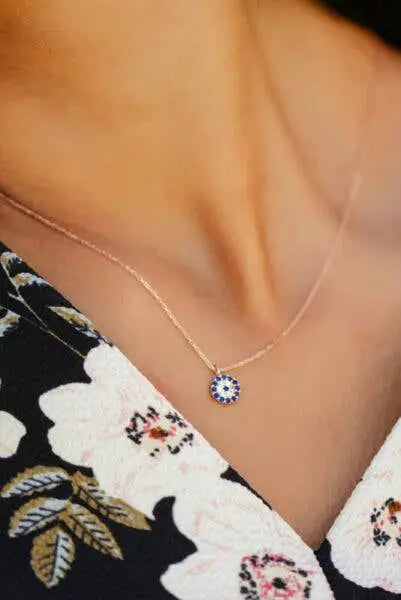 Einzelstück - 14K Gold Plated Evil Eye Rose Gold Necklace - Evil Eye Rose Gold Necklace - Rose Gold Necklaces Gift for Women worn on a delicate chain above a floral dress neckline.