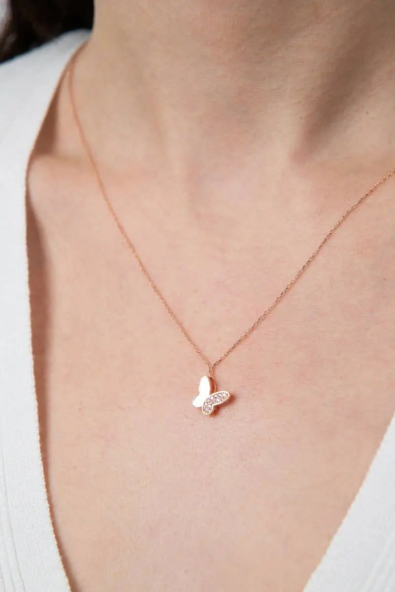Close-up of a delicate rose gold butterfly pendant necklace worn on a woman's neck, showcasing the Einzelstück - 14K Gold Plated Farfalle Necklace - Butterfly pendant Necklace - Gold Necklaces Gift for Women.