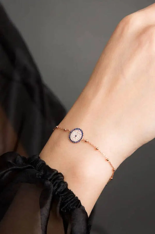 Einzelstück - 14K Gold Plated Nazar Rose Gold Bracelet with blue zircona crystals - Rose Gold Bracelet- Gold Bracelet Gift for Women displayed on a wrist with delicate chain and blue crystal accents.