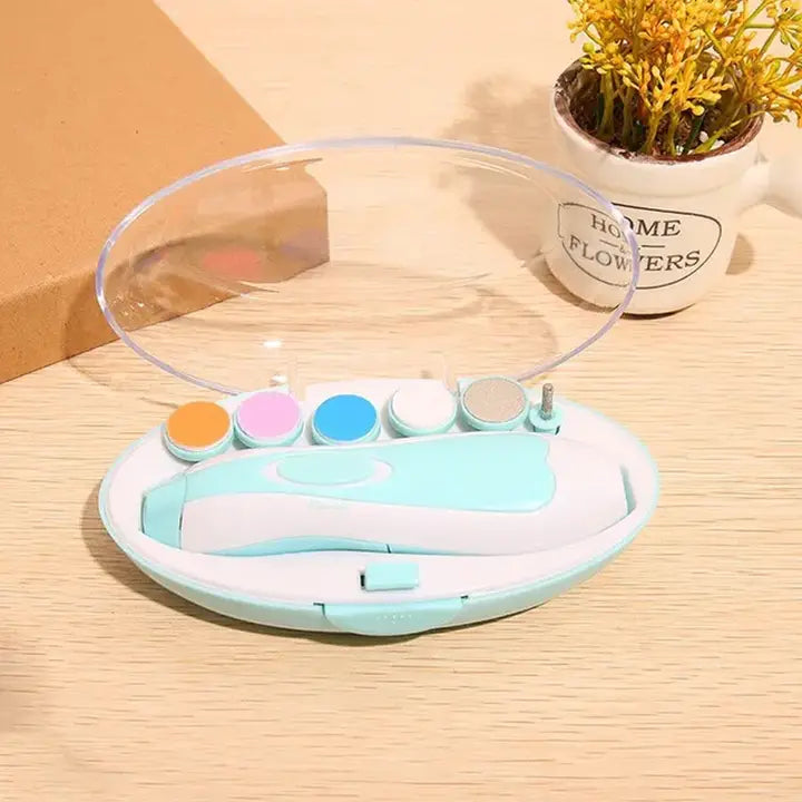 Electric Baby Nail File, Gentle Baby Electric Nail Trimmer, Electric Baby Nail Clipper with 7 Grinding Head Replacement Pads in a compact case with transparent lid on wooden surface next to small flower pot.