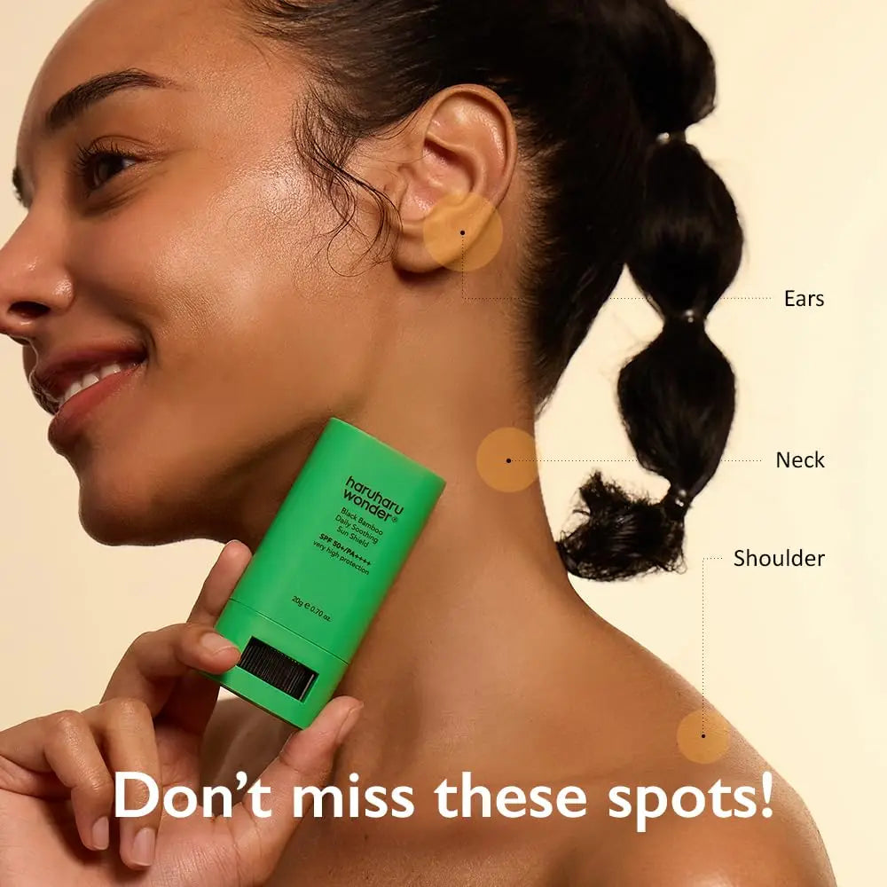 Smiling woman applying haruharu wonder Black Bamboo Daily Soothing Sun Shield Sunscreen Stick 20g to her neck and shoulder, highlighting ears, neck, and shoulder spots to protect.