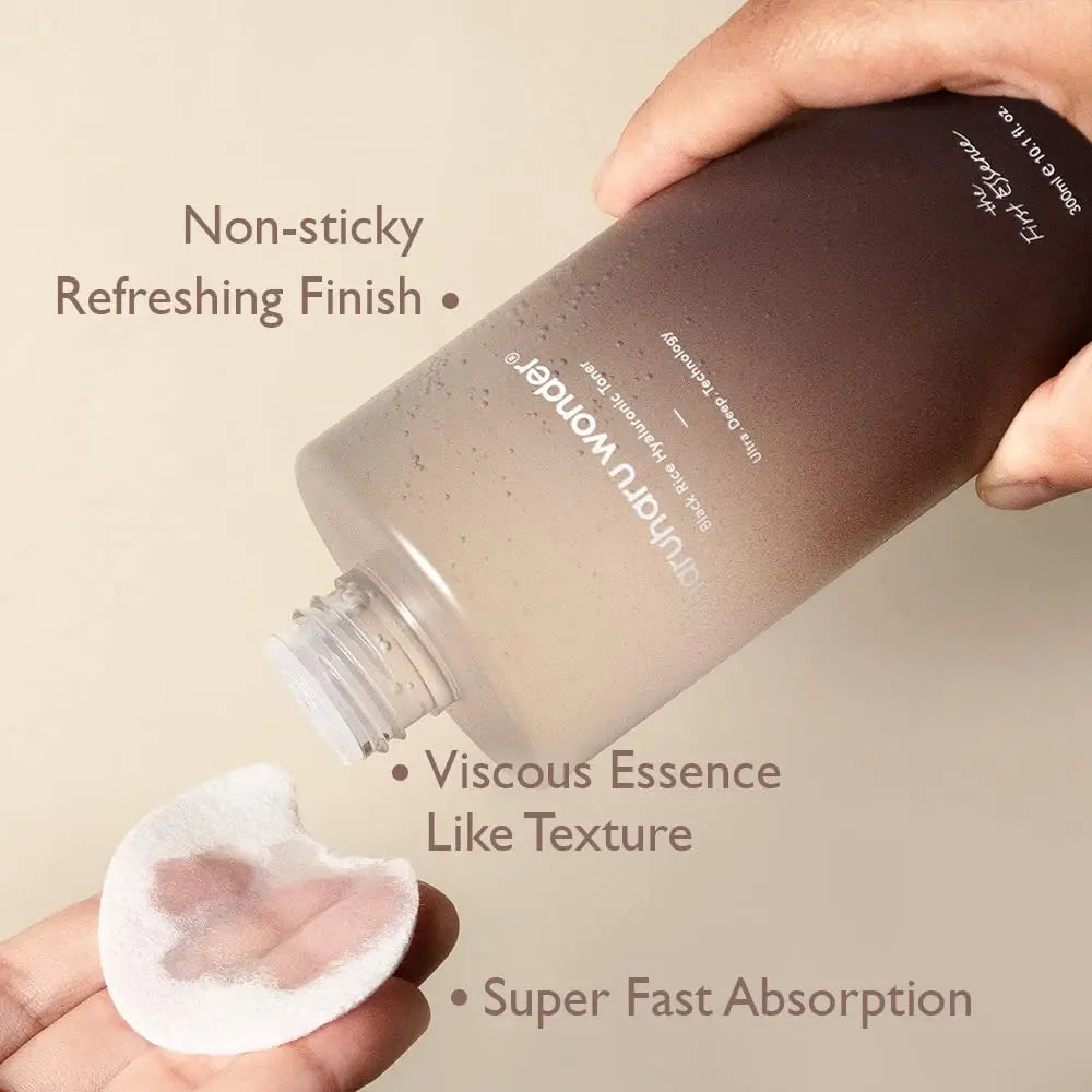 A hand holding a bottle of haruharu wonder Black Rice Hyaluronic Toner 300ml pouring a clear liquid onto a cotton pad demonstrating non-sticky, refreshing finish, viscous essence-like texture, and super fast absorption.