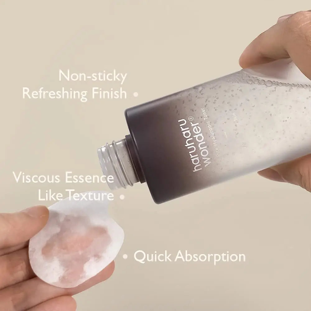 Hand holding haruharu wonder Black Rice Hyaluronic Toner for Sensitive Skin 50ml pouring clear liquid onto cotton pad, highlighting non-sticky, refreshing finish, viscous essence texture, and quick absorption features.
