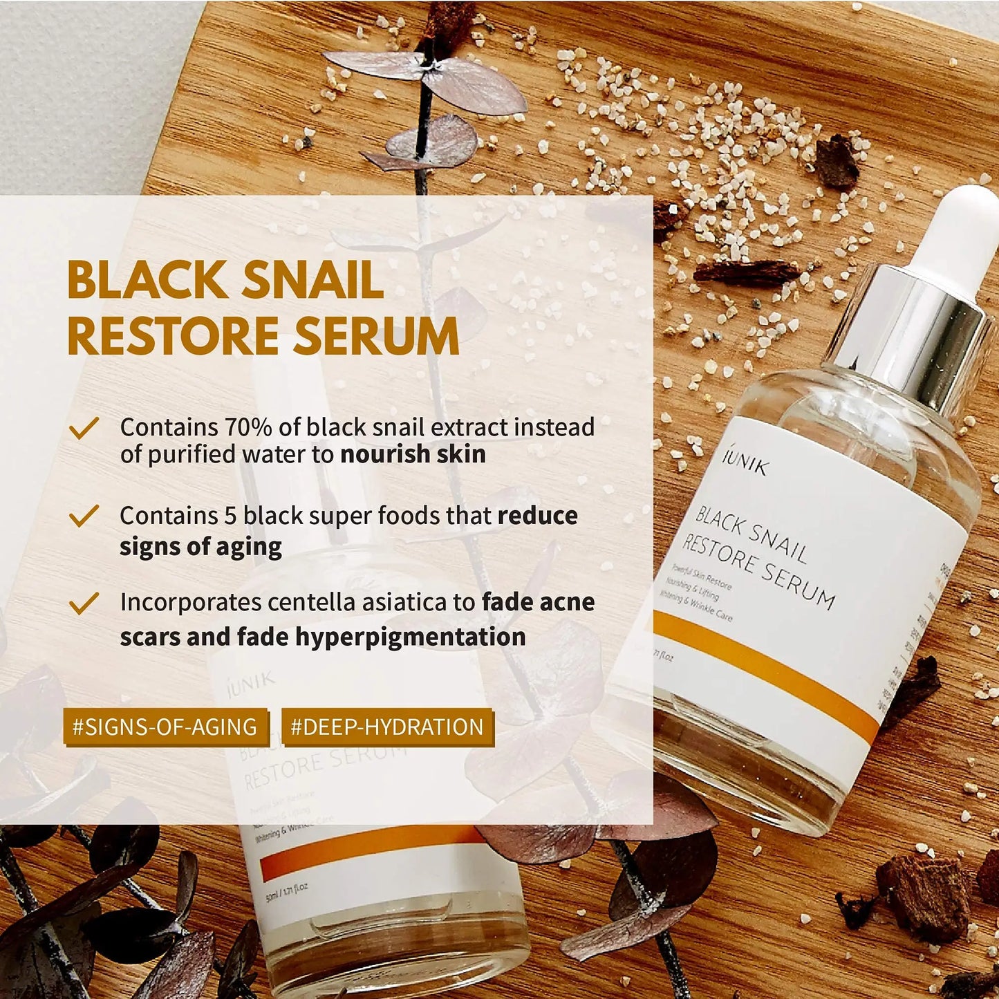 iUNIK Beta Glucan Power Moisture Serum 50m + iUNIK Black Snail Restore Serum 50ml bottles displayed on a wooden surface with text highlighting the Black Snail Restore Serum’s benefits for nourishing skin, reducing signs of aging, fading acne scars, and hyperpigmentation using black snail extract and superfoods.