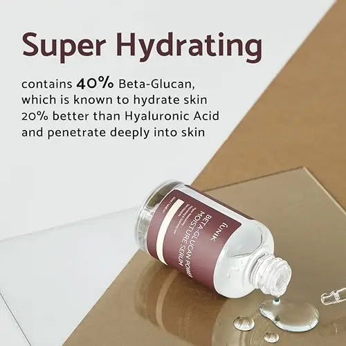 iUNIK Beta Glucan Power Moisture Serum 50ml bottle lying on a surface with clear serum liquid spilled beside it, highlighting super hydrating formula with 40% beta-glucan for deeper skin hydration than hyaluronic acid.