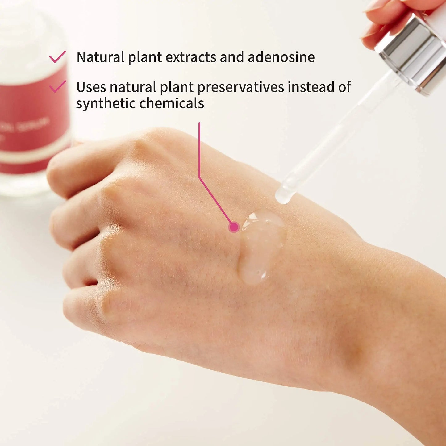 Close-up of a hand with clear serum applied, highlighting natural plant extracts and adenosine, promoting the iUNIK Beta Glucan Power Moisture Serum 50ml + iUNIK Noni Light Oil Serum 50ml using natural preservatives.
