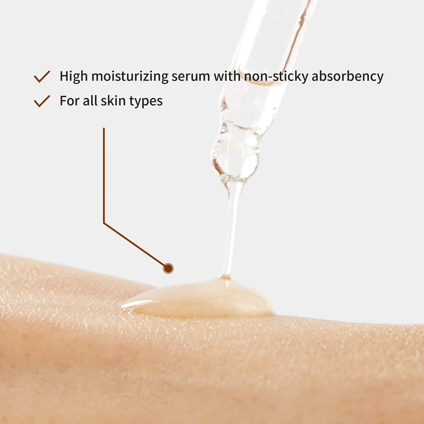 Close-up of clear serum being applied on skin with dropper, highlighting high moisturizing and non-sticky absorbency features of iUNIK Beta Glucan Power Moisture Serum 50ml + iUNIK Noni Light Oil Serum 50ml for all skin types.