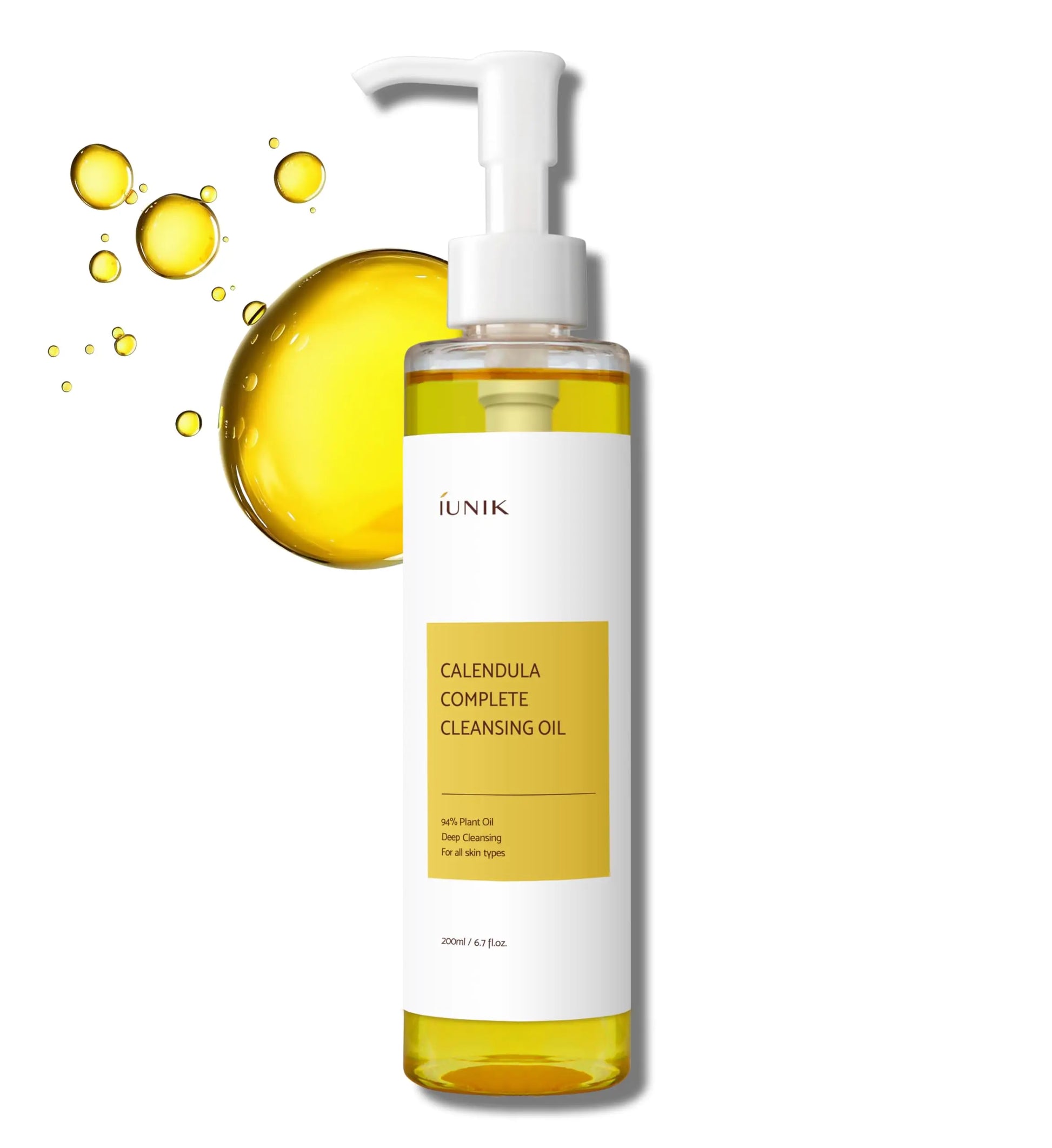 Clear pump bottle of iUNIK Calendula Complete Cleansing Oil, 200ml with golden oil droplets in the background, designed for deep facial cleansing and all skin types.
