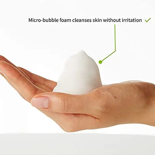 Close-up of a hand holding a mound of white micro-bubble foam representing gentle cleansing by iUNIK Calendula Complete Cleansing Oil, 200ml + iUNIK Centella Bubble Cleansing Foam, 150ml.