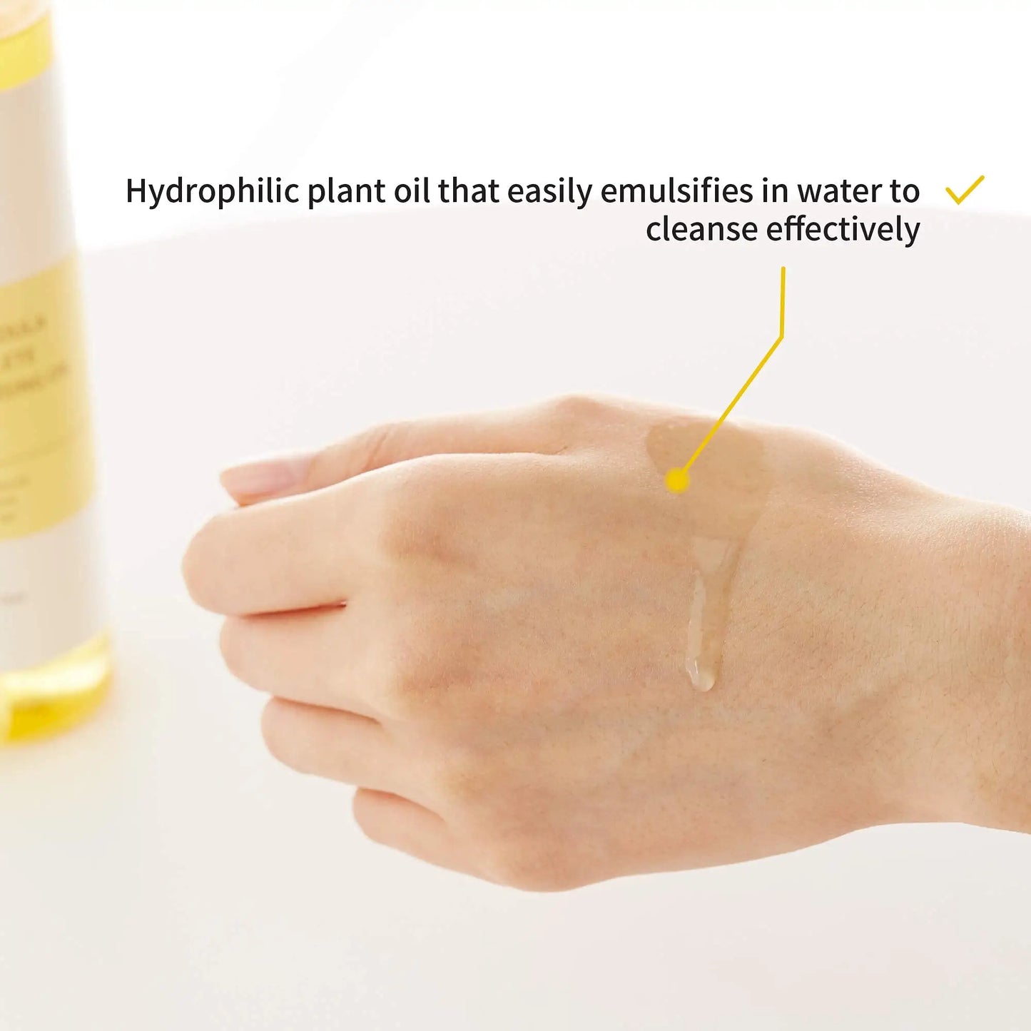 Close-up of a hand with a clear hydrophilic plant cleansing oil applied on the back, demonstrating its easy emulsification and effective cleansing from iUNIK Calendula Complete Cleansing Oil, 200ml + iUNIK Tea tree Relief Serum 50ml.