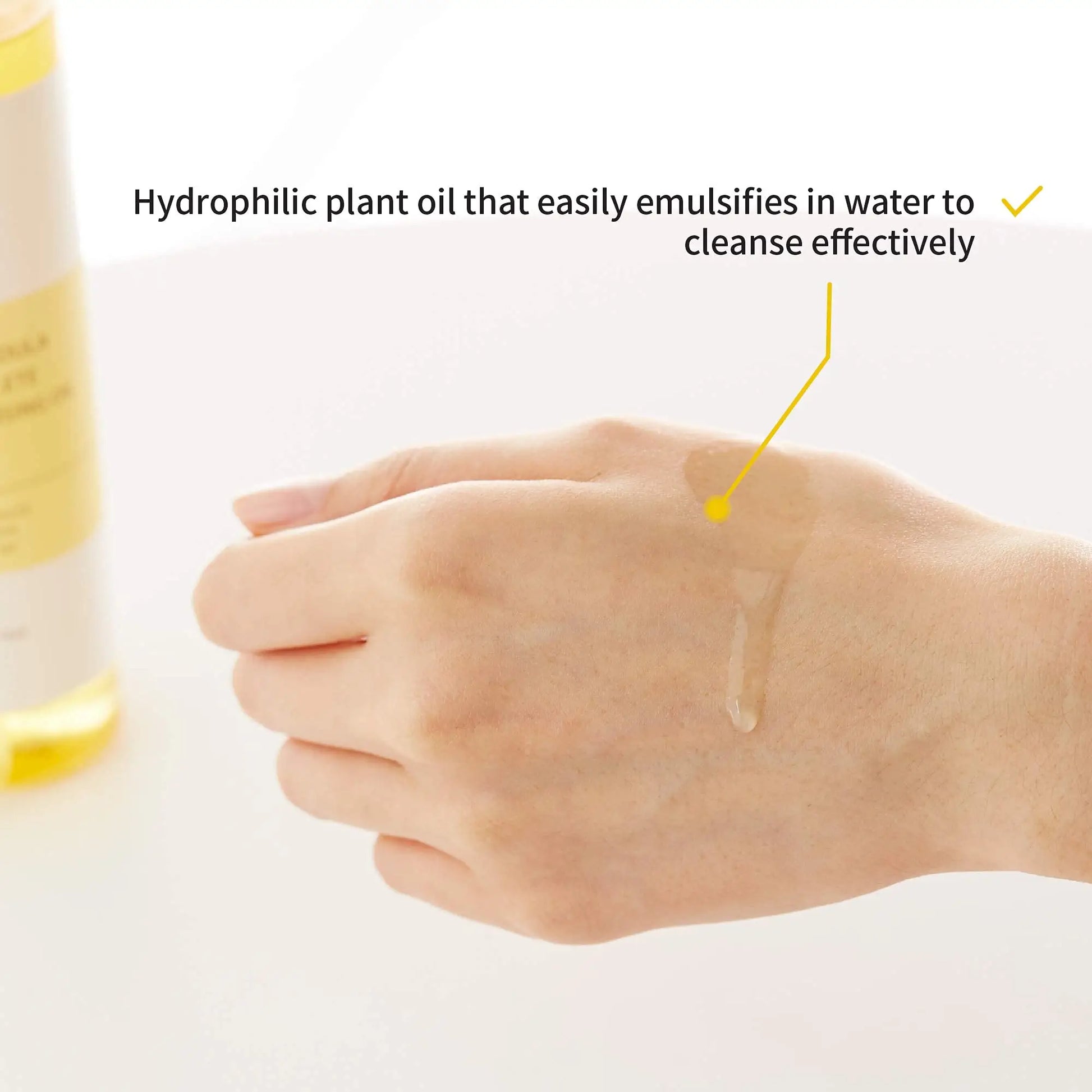 Close-up of a hand with a clear hydrophilic plant cleansing oil applied on the back, demonstrating its easy emulsification and effective cleansing from iUNIK Calendula Complete Cleansing Oil, 200ml + iUNIK Tea tree Relief Serum 50ml.