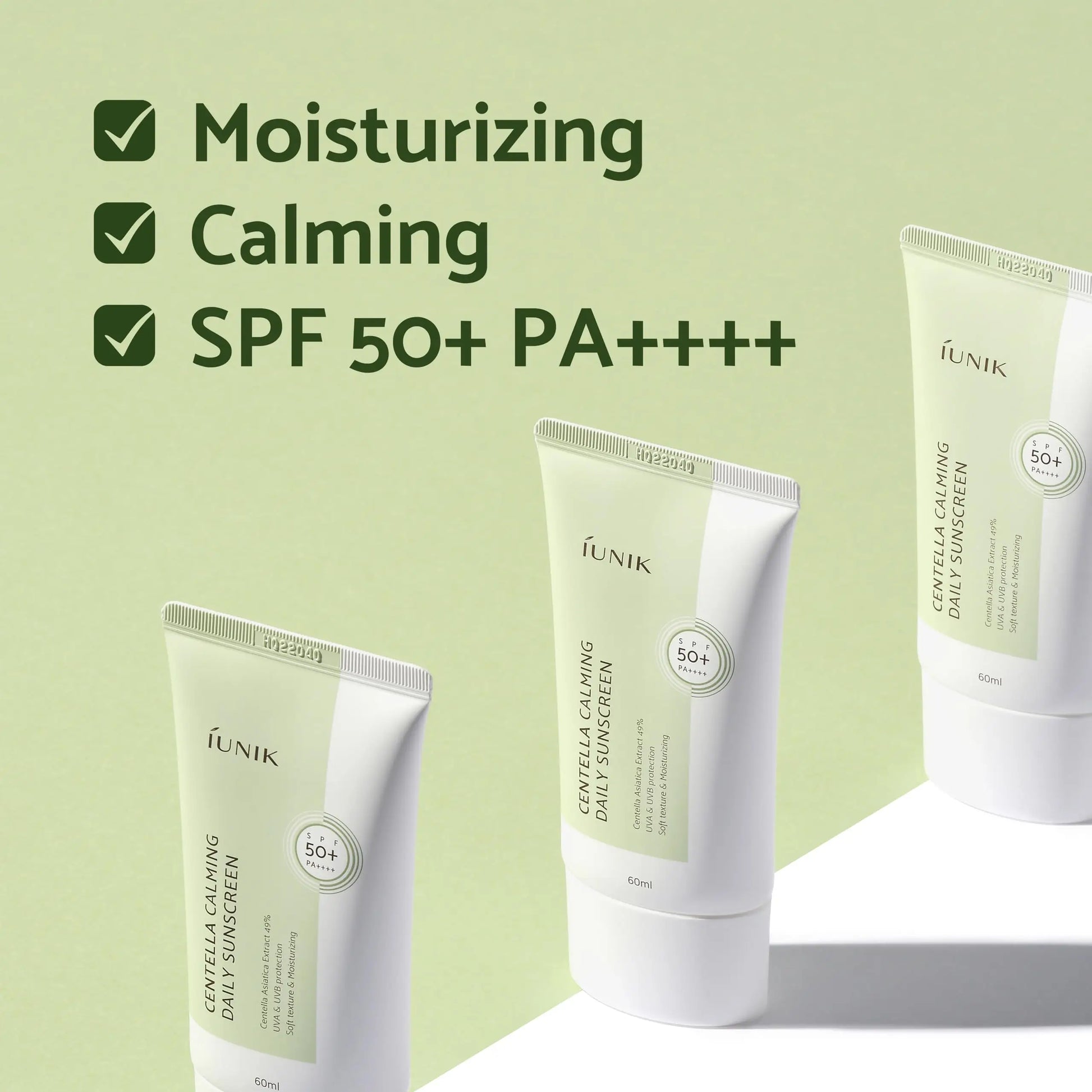 Three tubes of iUNIK Centella Calming Daily Sunscreen 60ml displayed on a green background with text highlighting moisturizing, calming, and SPF 50+ PA++++ features, part of iUNIK Centella Calming Daily Sunscreen 60ml + iUNIK Tea tree Relief Serum 50ml set.