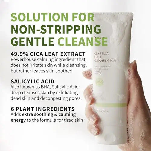 Hand holding a foaming tube of iUNIK Centella Mild Cleansing Foam, 120ml, with visible bubbles and text highlighting its gentle, non-stripping formula containing 49.9% cica leaf extract, salicylic acid, and six plant ingredients for soothing and calming skin.