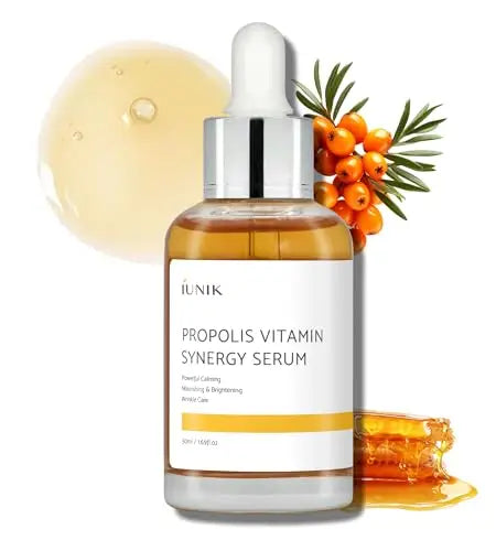 iUNIK Propolis Vitamin Synergy Serum, 50ml bottle with dropper, accompanied by propolis resin, sea buckthorn berries, and a swatch of serum texture representing brightening and nourishing skincare benefits.