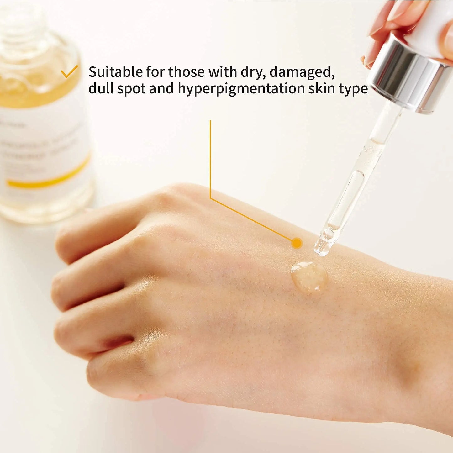 Close-up of a hand applying a clear serum drop from a pipette, highlighting suitability for dry, damaged, dull spots, and hyperpigmentation skin types with iUNIK Propolis Vitamin Synergy Serum, 50ml + iUNIK Tea tree Relief Serum 50ml.