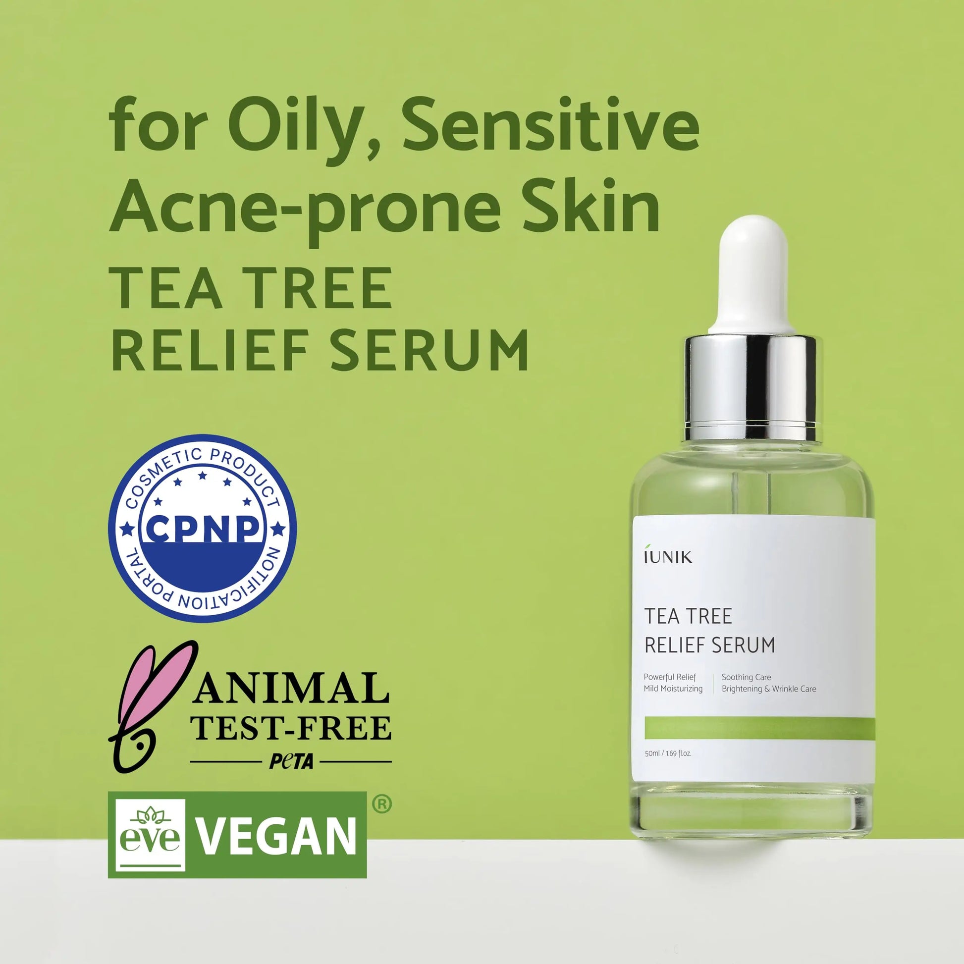 iUNIK Tea tree Relief Serum 50ml bottle with dropper on green background labeled for oily, sensitive, acne-prone skin, featuring cosmetic product certification, animal test-free, and vegan logos.