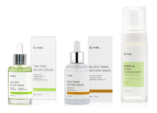 Set of iUNIK Tea tree Relief Serum 50ml, iUNIK Black Snail Restore Serum 50ml, and iUNIK Centella Bubble Cleansing Foam, 150ml displayed with packaging on a white background.