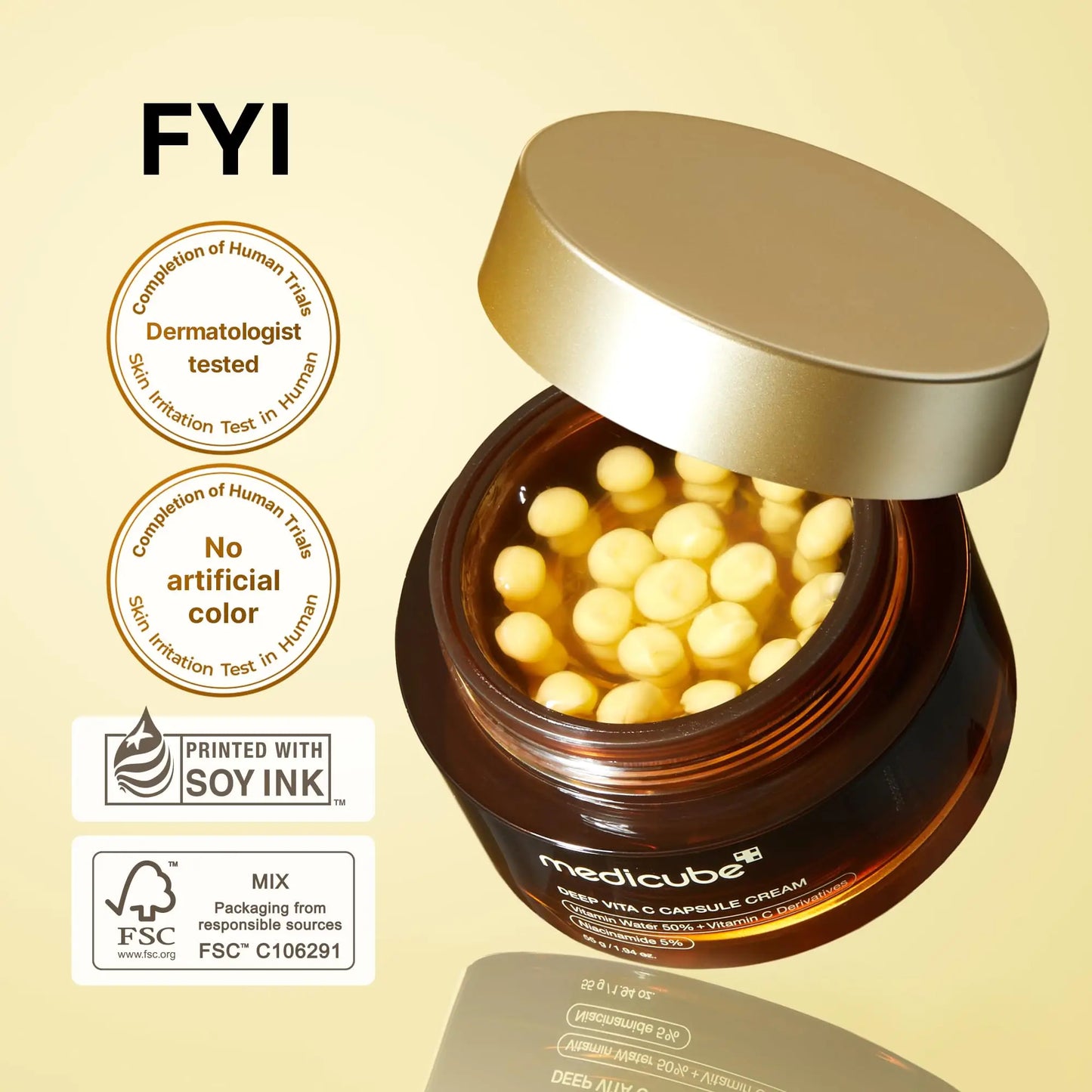 Open brown jar of medicube Deep Vitamin C Capsule Cream 55g showing yellow capsule-shaped cream inside with gold lid partially off, accompanied by dermatologist tested and no artificial color badges.
