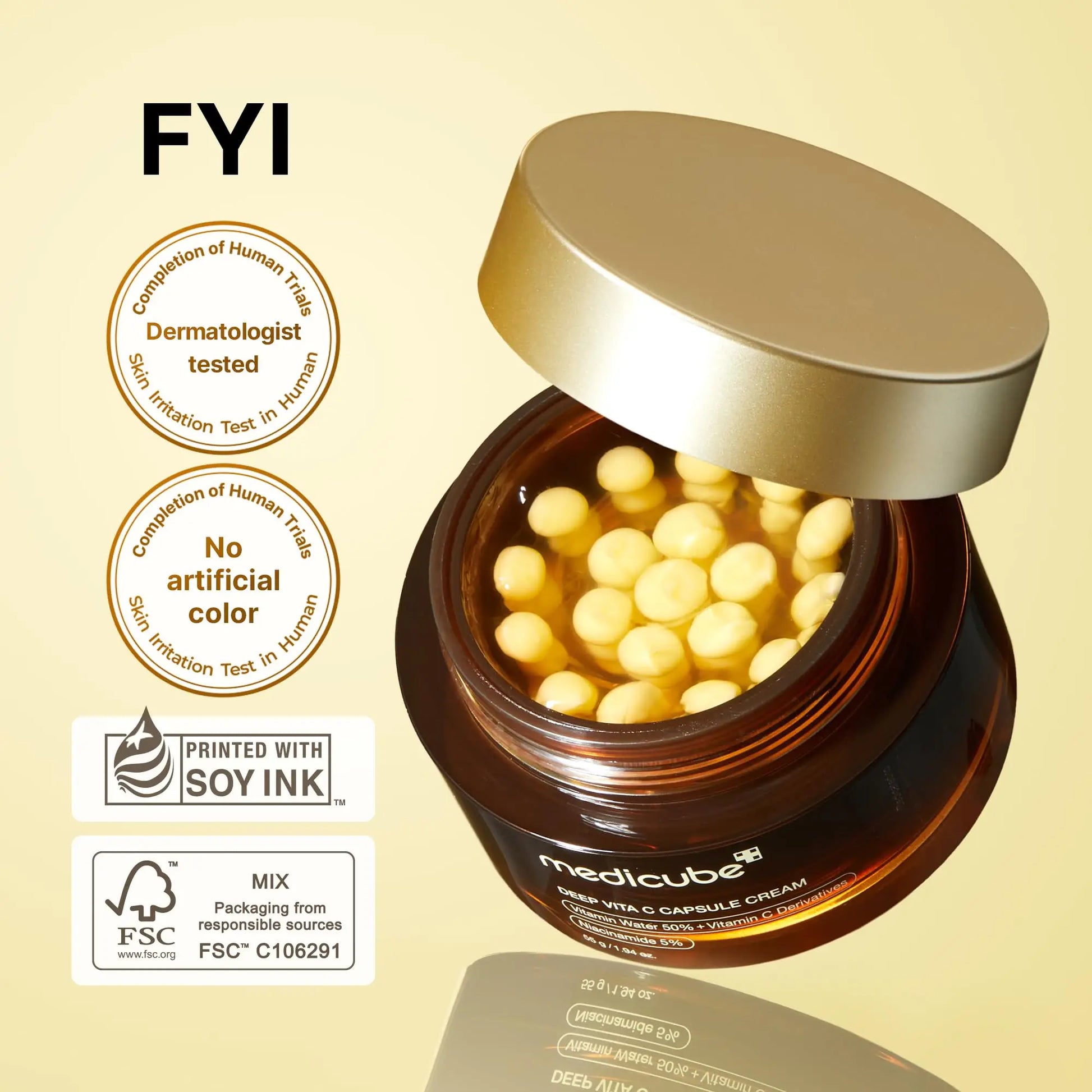 Open brown jar of medicube Deep Vitamin C Capsule Cream 55g showing yellow capsule-shaped cream inside with gold lid partially off, accompanied by dermatologist tested and no artificial color badges.