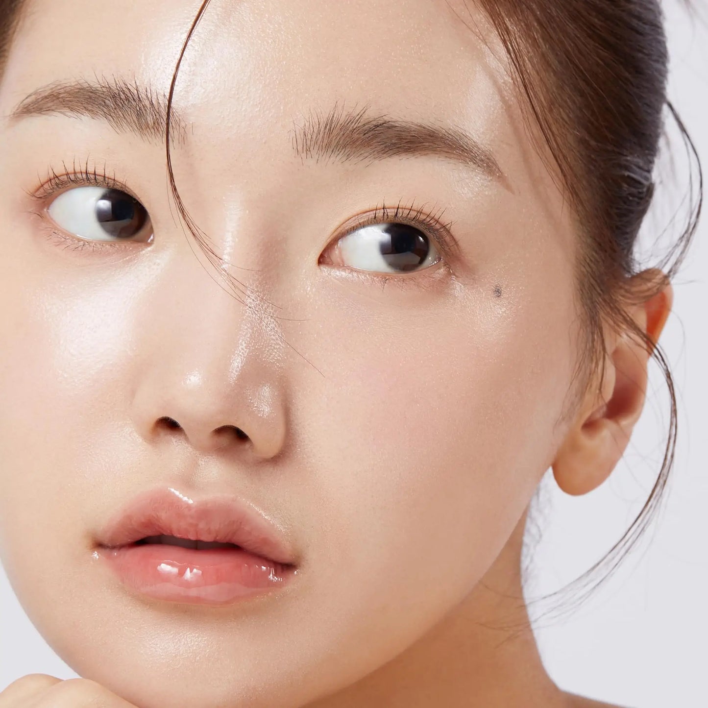 Close-up of a woman with glowing, dewy skin showcasing the effect of medicube Triple Collagen Serum 55ml for smooth and hydrated facial skin.