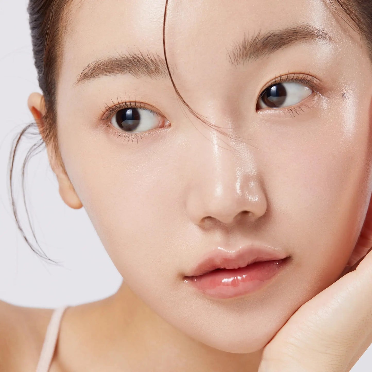 Close-up of a woman with smooth, glowing skin and natural makeup showcasing the effects of medicube Triple Collagen Toner 140ml for hydrated, radiant facial skin.