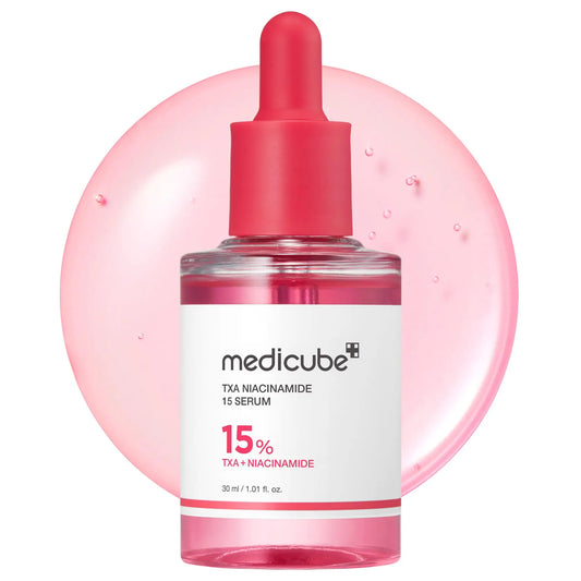 medicube TXA Niacinamide 15 Serum 30ml in a clear glass bottle with a red dropper cap, shown with a translucent pink serum droplet background highlighting the formula’s texture.